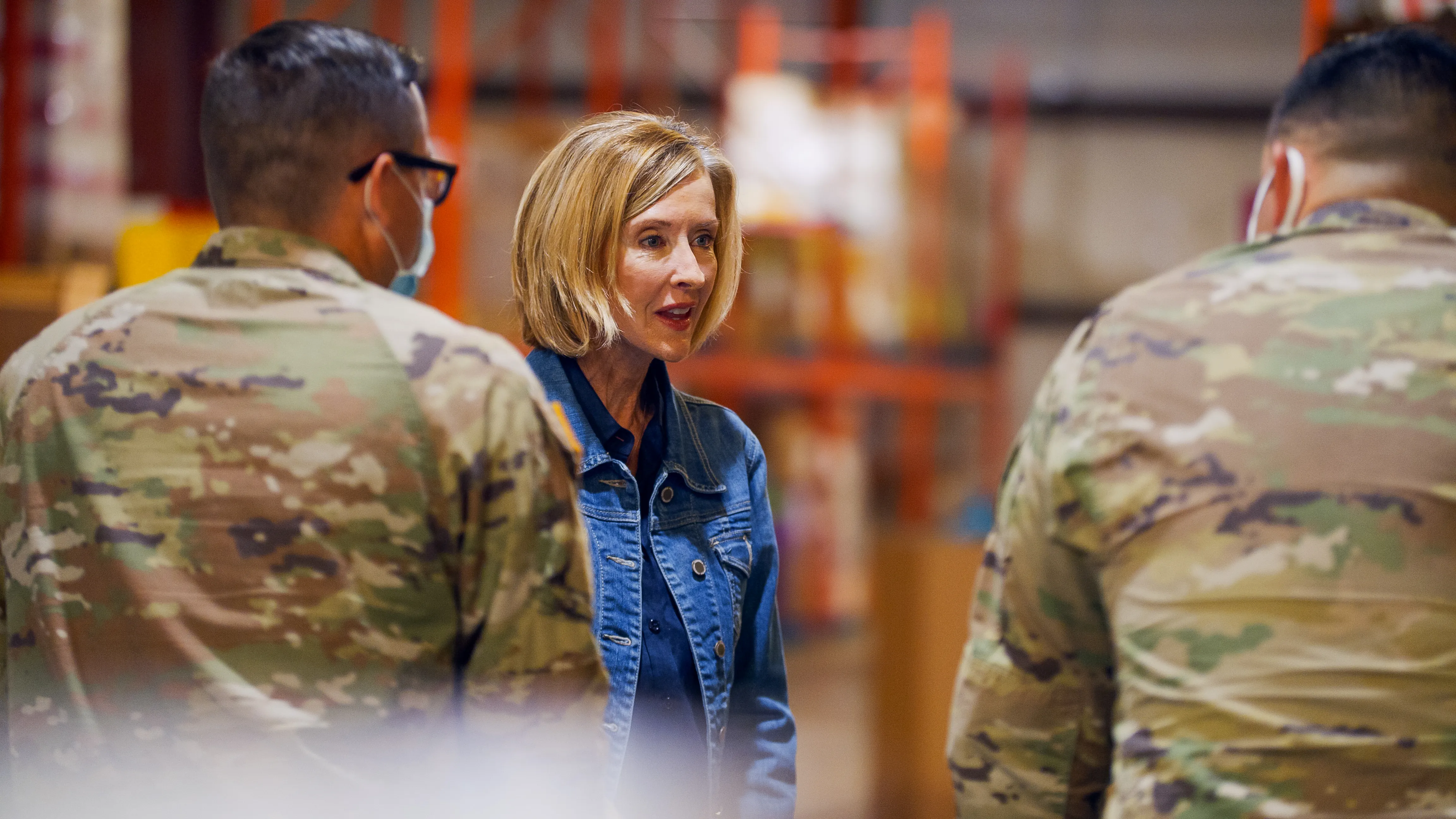 Karrin Taylor Robson talking with soldiers